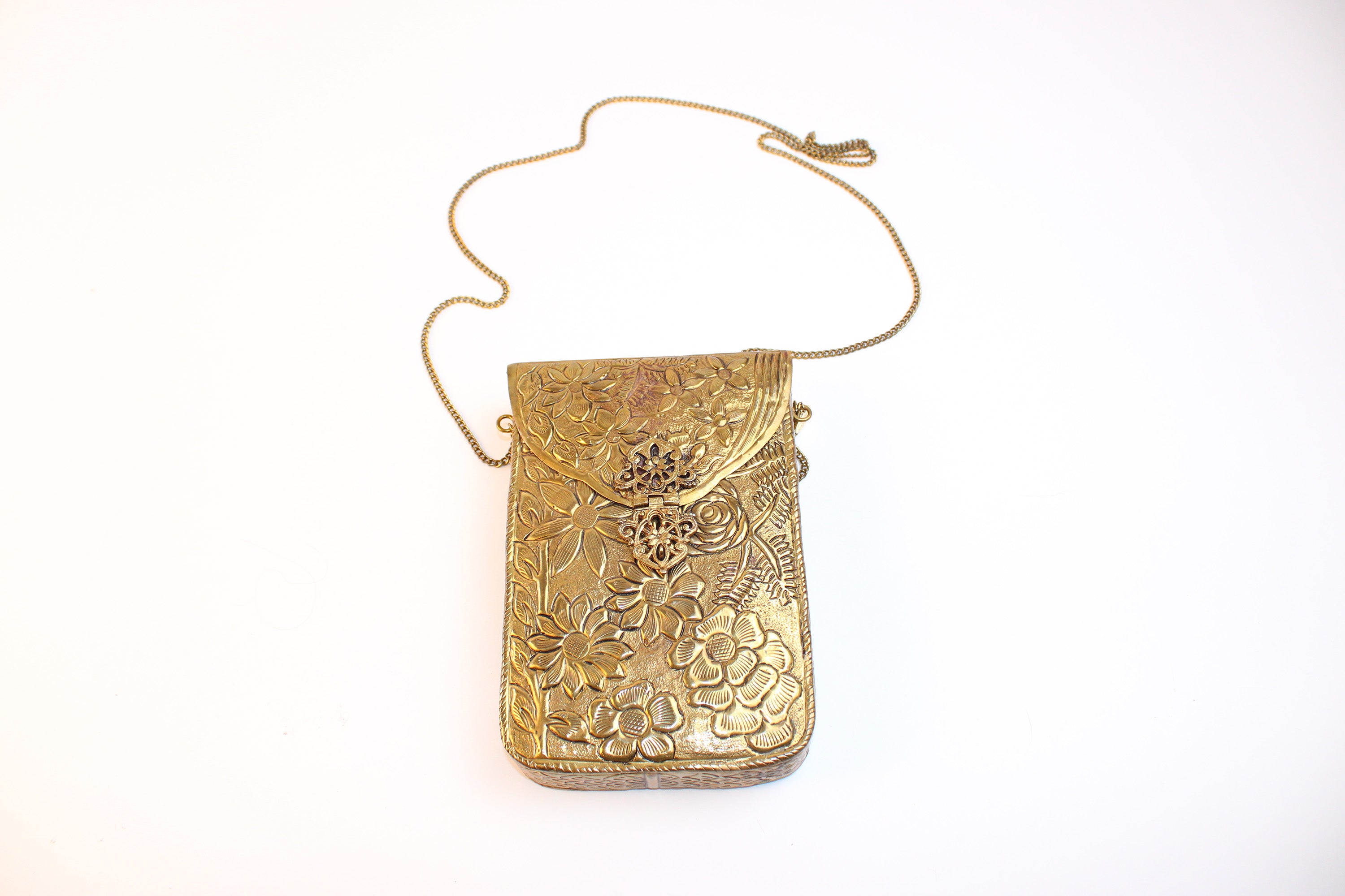 From St Xavier gold embossed floral metal mini crossbody evening bag with chain stra