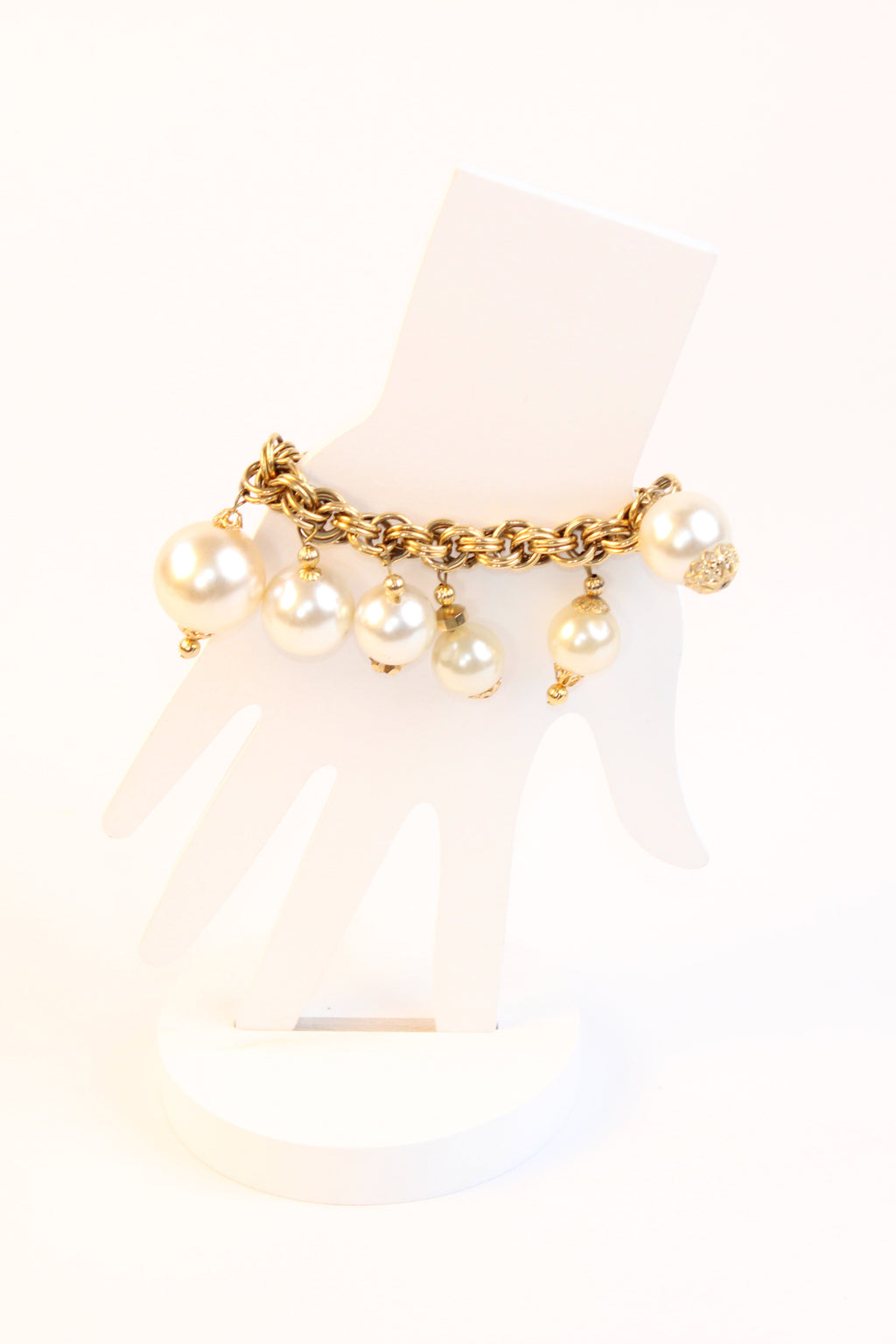 Gold tone chain bracelet with pearl drop charms