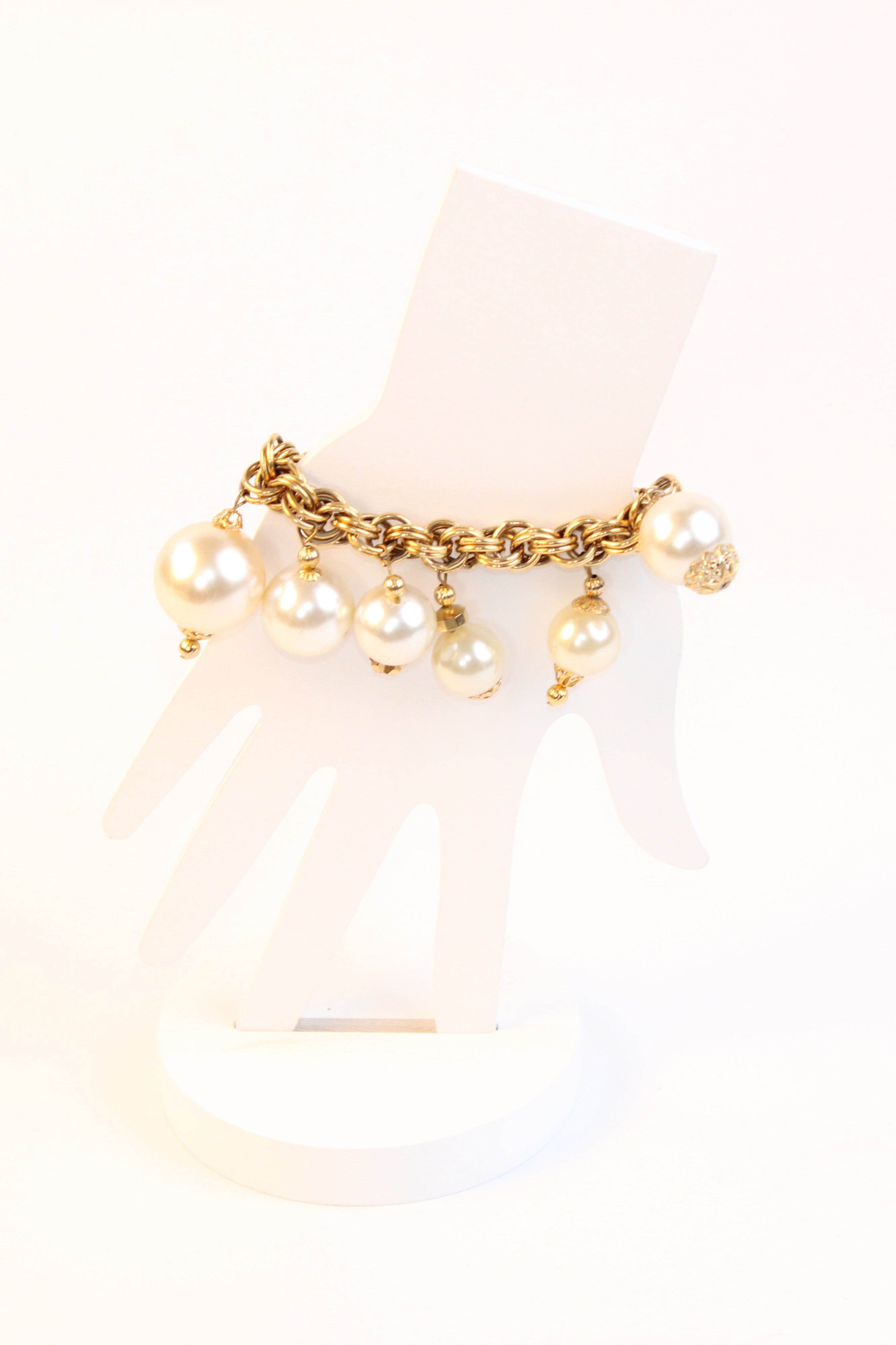 Gold tone chain bracelet with pearl drop charms