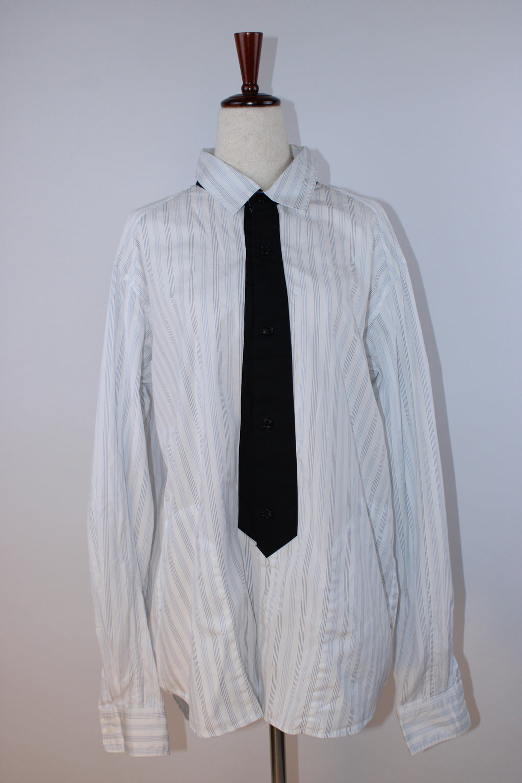 Neighborhood white pinstripe button-down shirt with gray pinstripes and black tie-inspired contrast placket displayed on a mannequin.