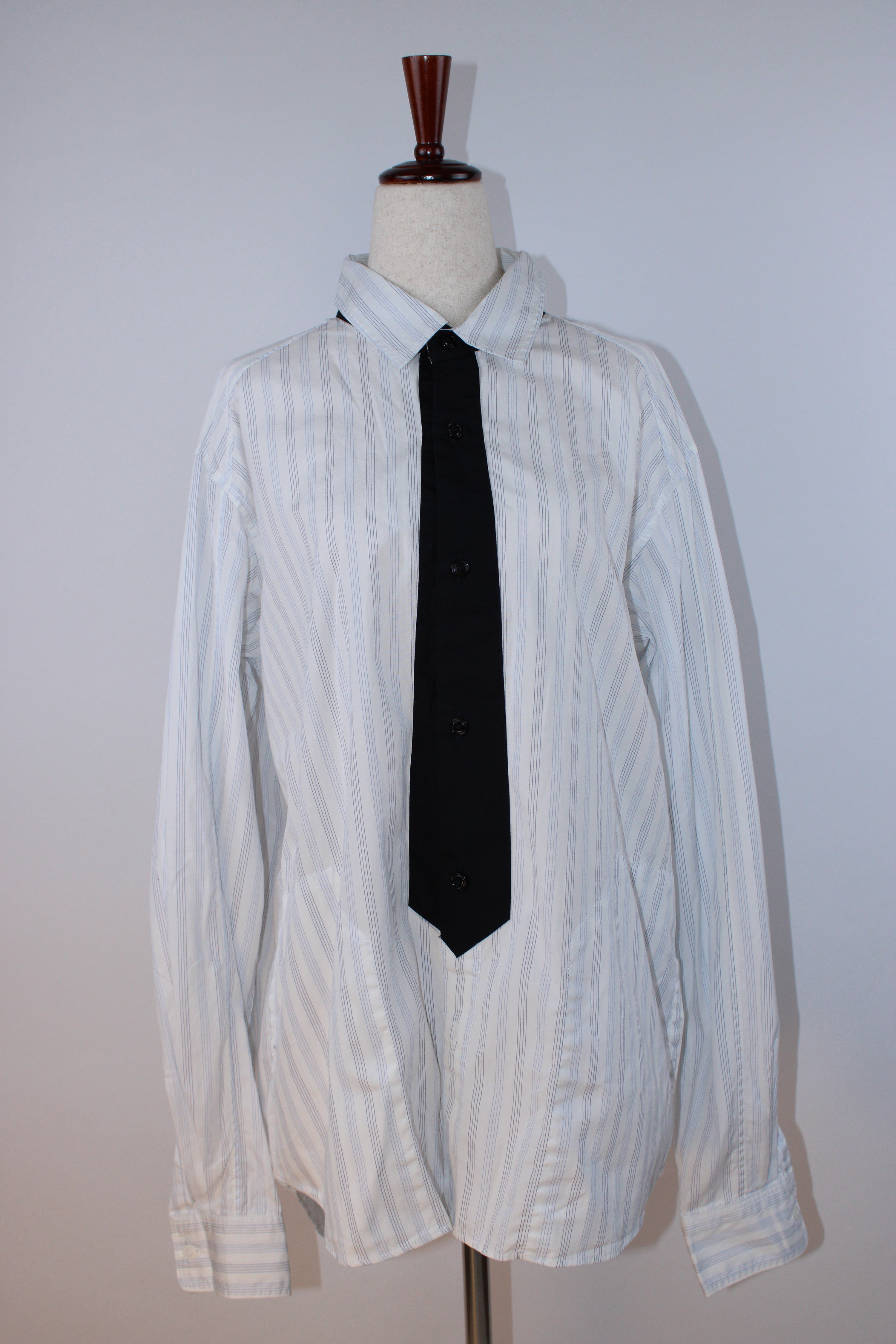Neighborhood white pinstripe button-down shirt with gray pinstripes and black tie-inspired contrast placket displayed on a mannequin.