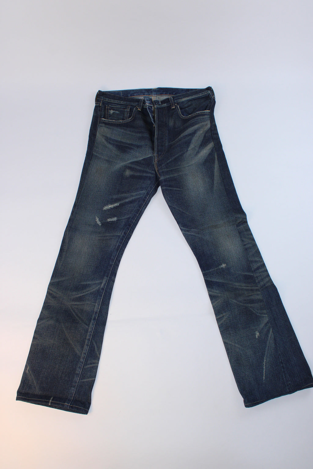 Levi's 501 XX dark wash straight-leg jeans featuring a classic button-fly closure, factory distressing, signature leather patch, and five-pocket design.