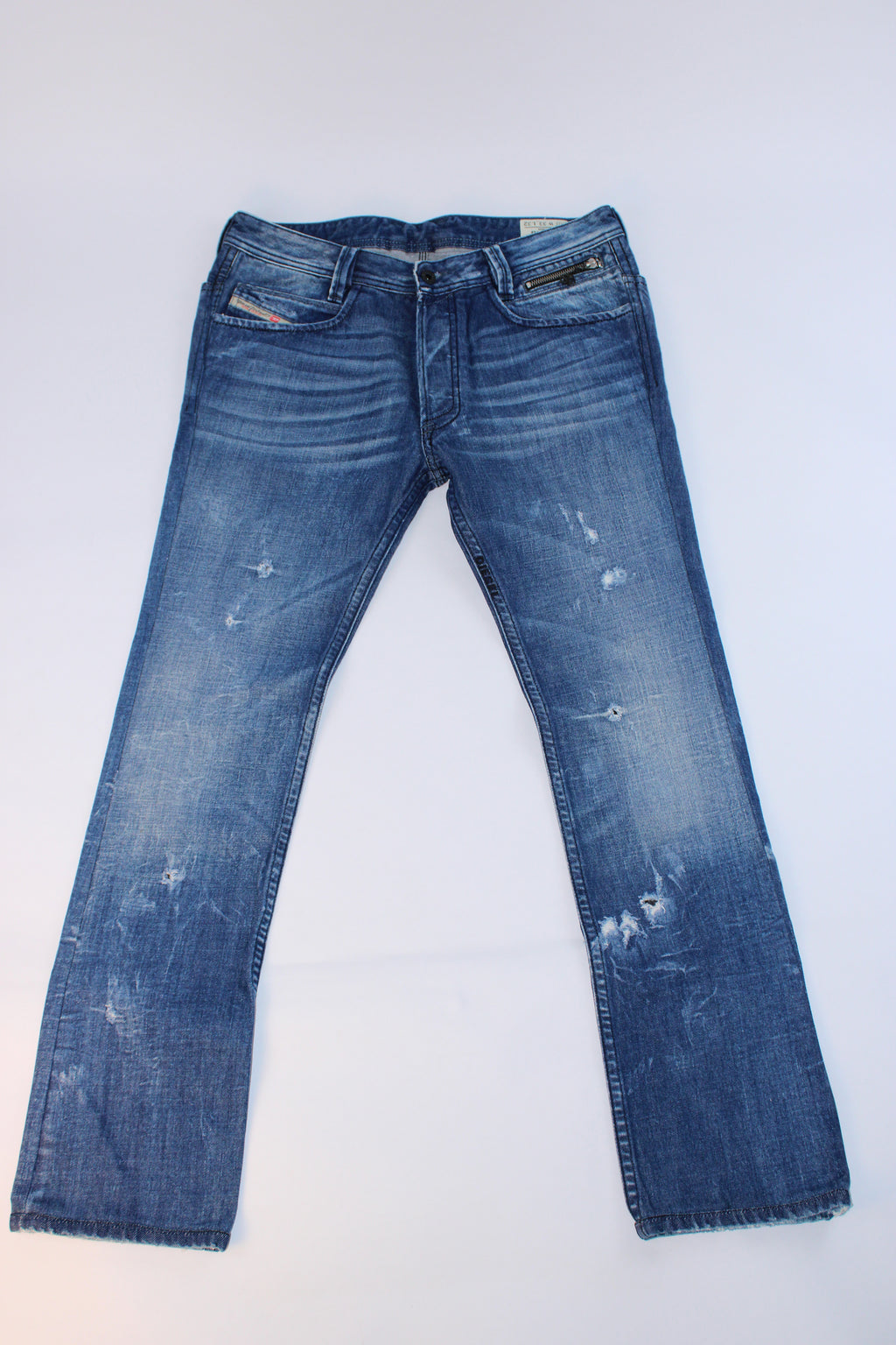 Diesel PADDOP straight-leg jeans in Wash 0073J featuring distressed detailing, button-fly closure, zippered coin pocket, pyramid stud accents, and premium Italian denim.