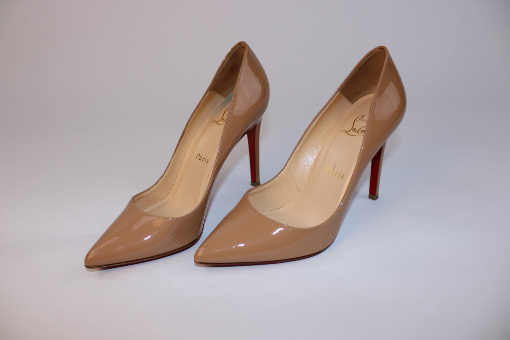 Christian Louboutin Pigalle nude patent leather pointed toe pumps with signature red lacquer soles and high stiletto heels.